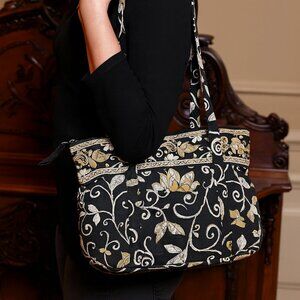 Vera Bradley quilted shoulder handbag in a black, white, and yellow floral